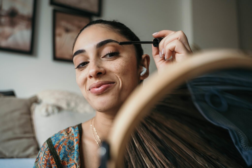 beautiful woman using mascara.